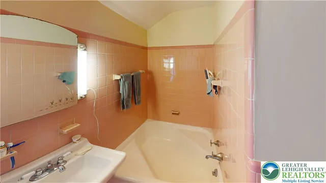 a bathroom with a tub and shower