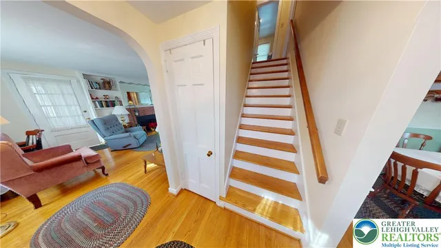 a view of a living room with furniture and stairs