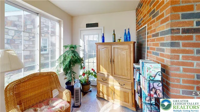 a living room filled with furniture and a potted plant