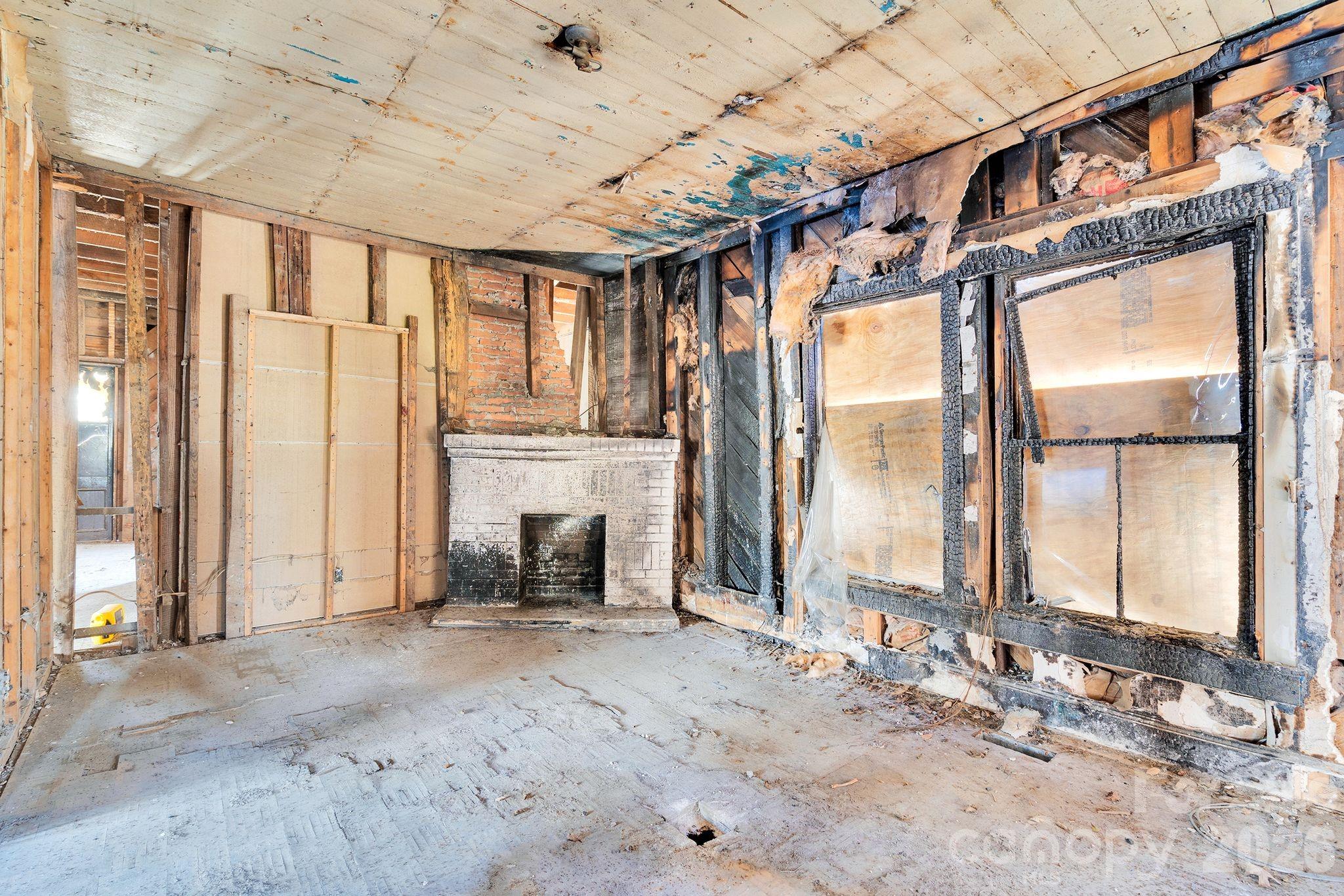 4521 Edgeland Road Edgemoor, SC 29712 - Photo 12 of 48 a view of an empty room with a fireplace and a window