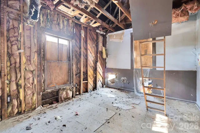 a view of a house with a yard covered with snow
