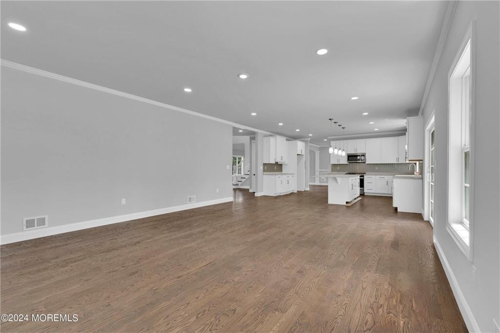 160 Freneau Avenue Matawan, NJ 07747 - Photo 6 of 8 a view of kitchen with white cabinets and wooden floor