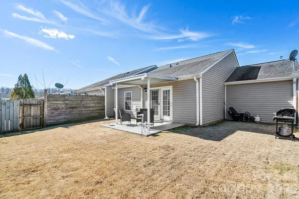 a view of a house with wooden roof and sitting area