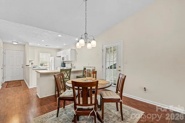a view of a dining room with furniture and wooden floor