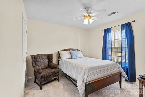 a bedroom with a bed couch and window