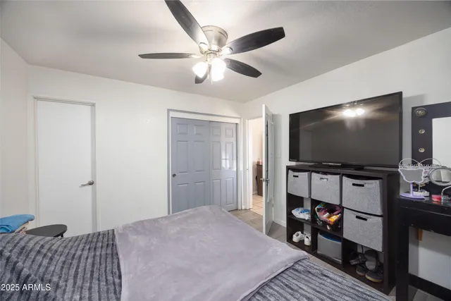 a bedroom with bed and flat screen tv