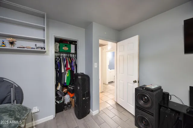 a view of walk in closet with clothes and shoes