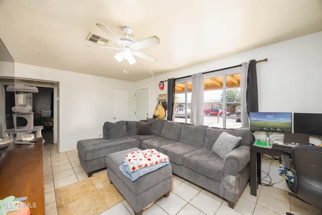 a living room with furniture a rug and a flat screen tv