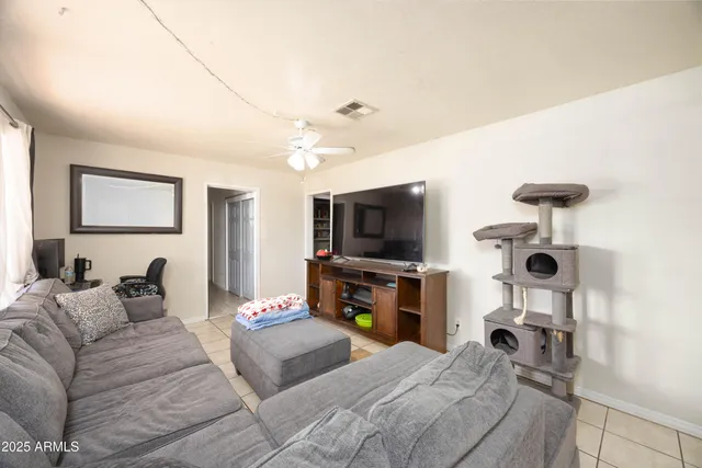 a bedroom with a bed and a flat tv screen on wall