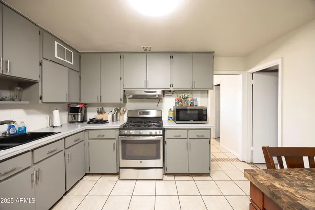 a kitchen with a stove a sink and a refrigerator