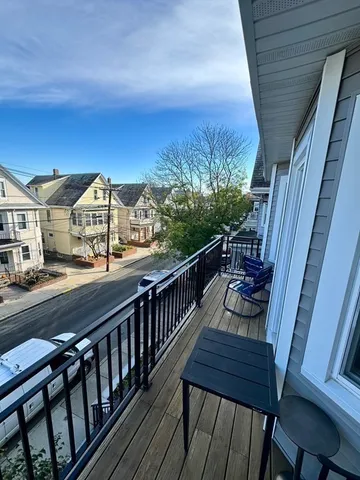 a view of a balcony with furniture