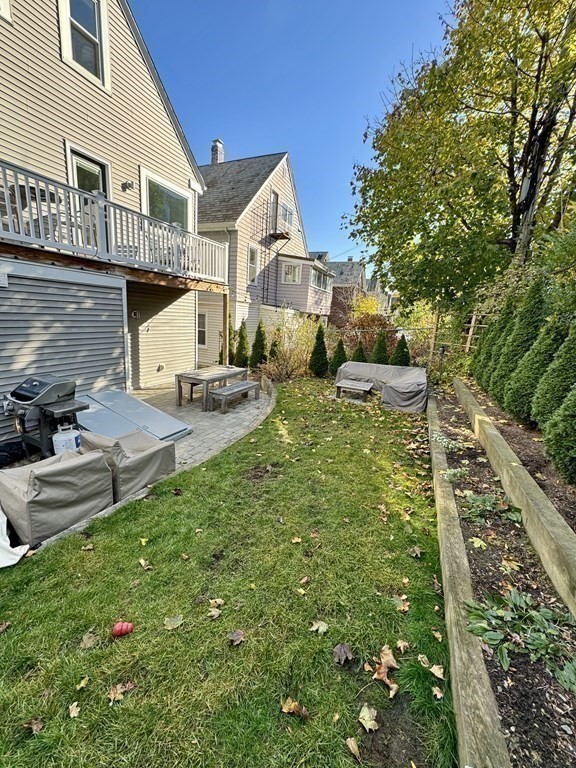 122 Hudson Street, Unit 2 Somerville, MA 02144 - Photo 14 of 15 a front view of a house with garden