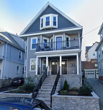 a front view of a house with garden