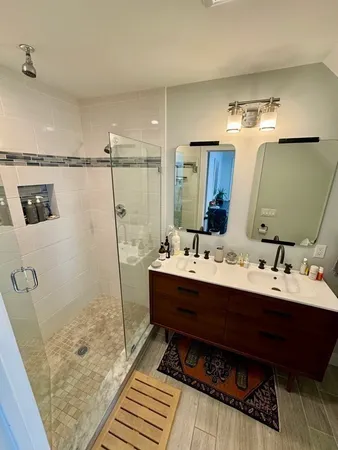 a bathroom with a tub sink and mirror