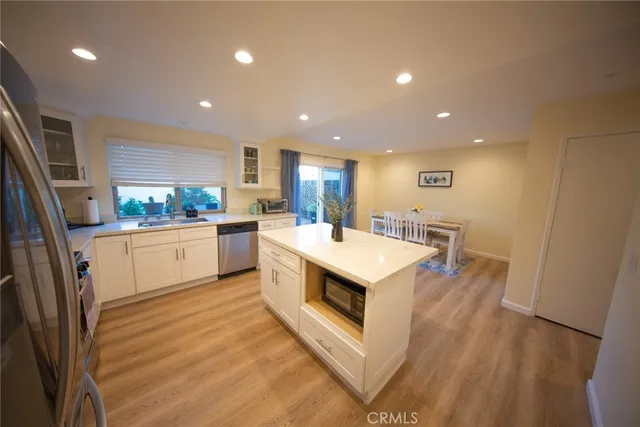 a kitchen with a sink and wooden floor
