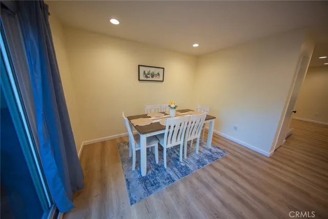 a dining room with furniture and wooden floor