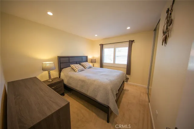 a bedroom with a bed and a night stand