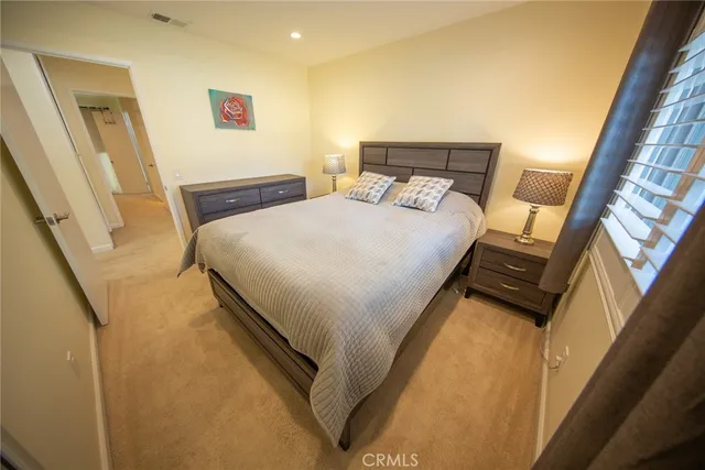 a bed sitting in a bedroom next to a window