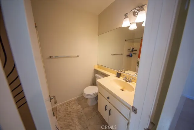 a bathroom with a sink and mirror with toilet