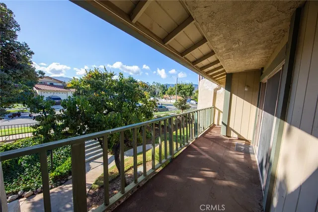 a view of a balcony with wooden floor