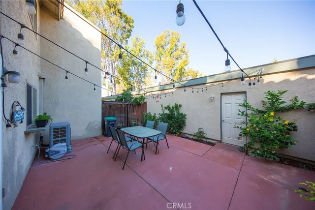 a backyard of a house with table and chairs