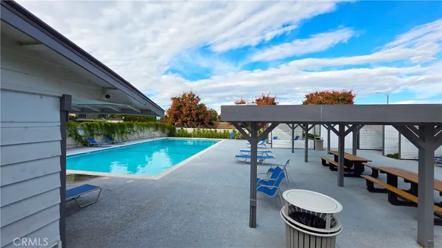 a view of a house with swimming pool and sitting area