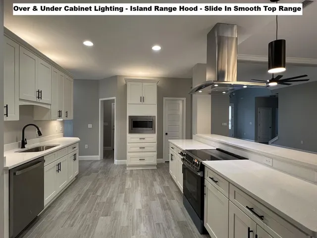 a kitchen that has a lot of cabinets in it and stainless steel appliances