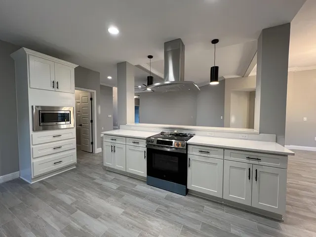 a kitchen with stainless steel appliances a stove and a refrigerator