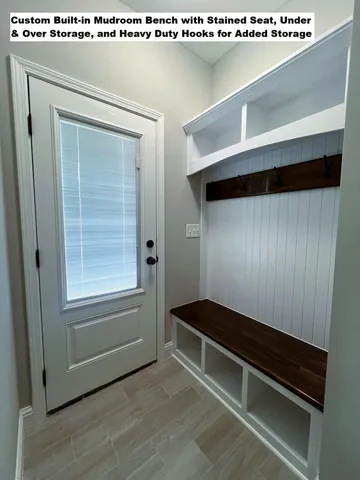 a hallway with sliding door and wooden floor