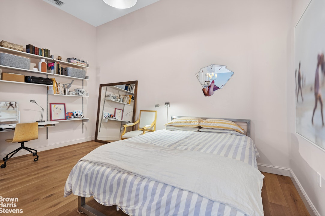 220 West 148th Street, Unit 4B Manhattan, NY 10039 - Photo 3 of 15 a bedroom with a bed and wooden floor