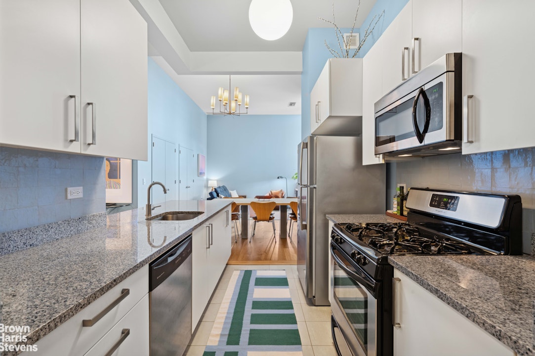 220 West 148th Street, Unit 4B Manhattan, NY 10039 - Photo 5 of 15 a kitchen with stainless steel appliances granite countertop a stove a sink and a microwave