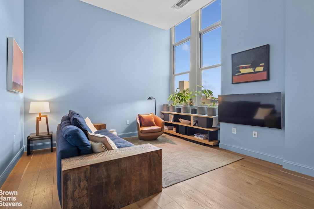 220 West 148th Street, Unit 4B Manhattan, NY 10039 - Photo 7 of 15 a living room with furniture and a flat screen tv