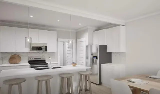 a kitchen with stainless steel appliances granite countertop a stove a refrigerator and a refrigerator