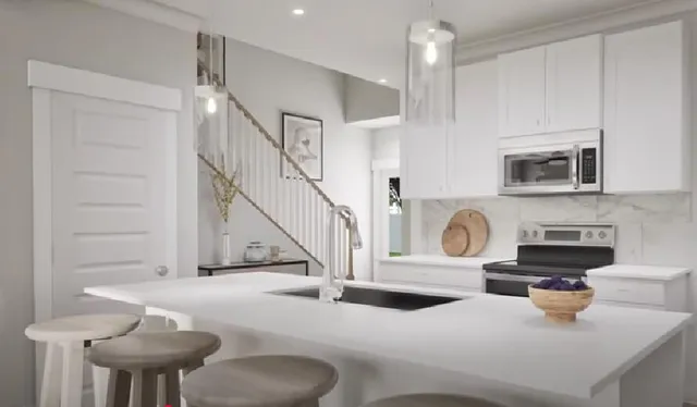 a kitchen with a stove a sink and a microwave