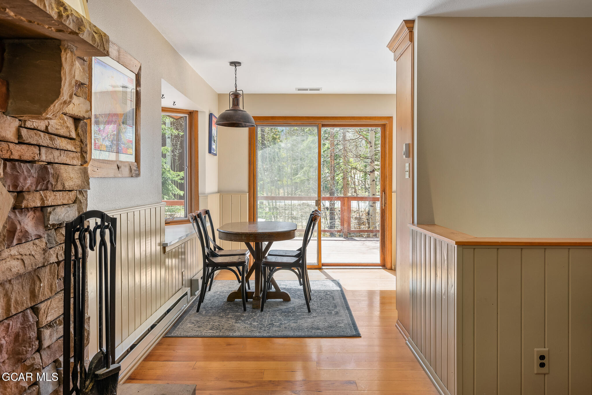 614 Vasquez Road Winter Park, CO 80482 - Photo 11 of 52 a dining room with furniture a rug and a floor to ceiling window