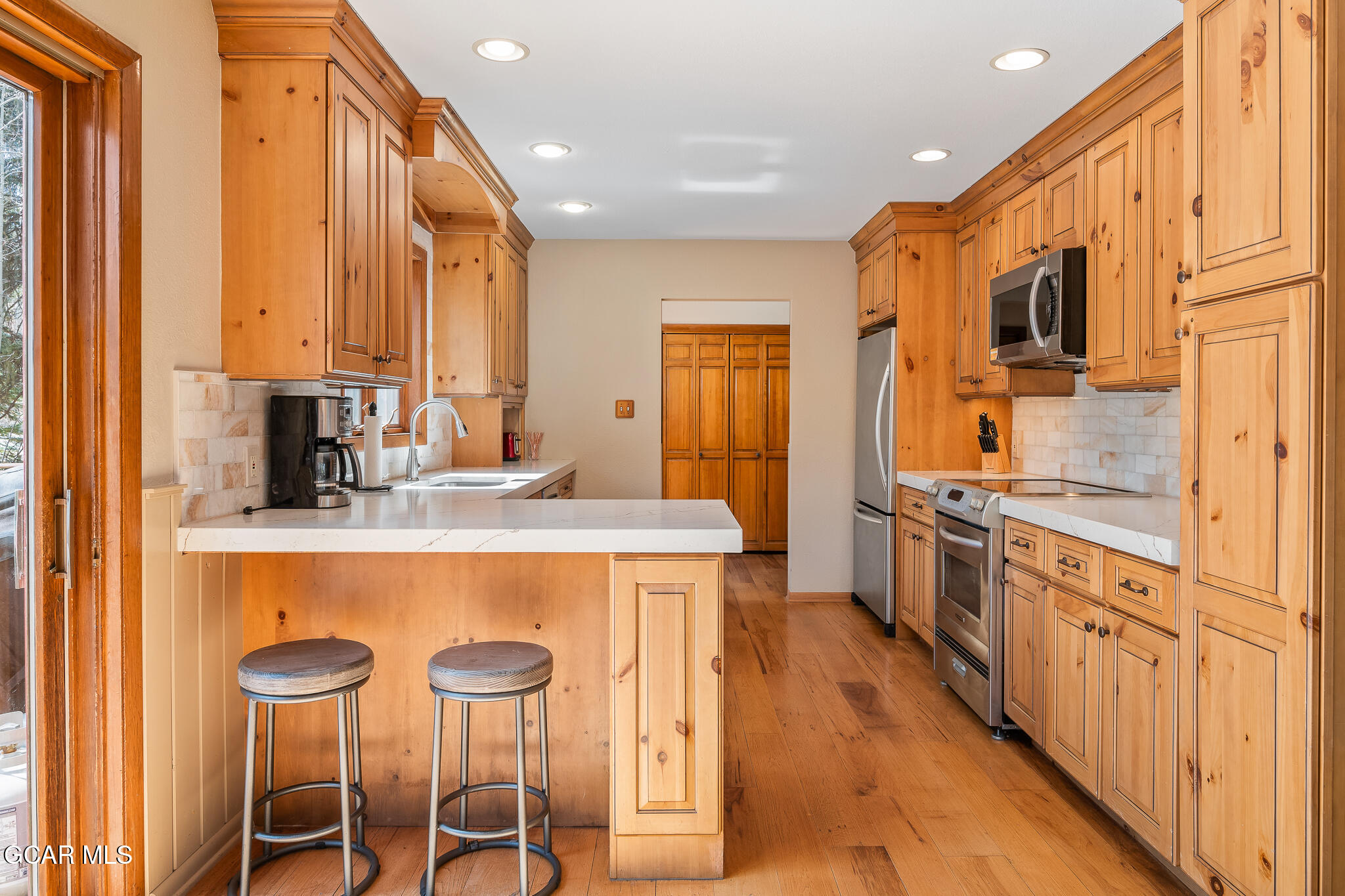 614 Vasquez Road Winter Park, CO 80482 - Photo 14 of 52 a kitchen with stainless steel appliances kitchen island granite countertop a table chairs and a refrigerator