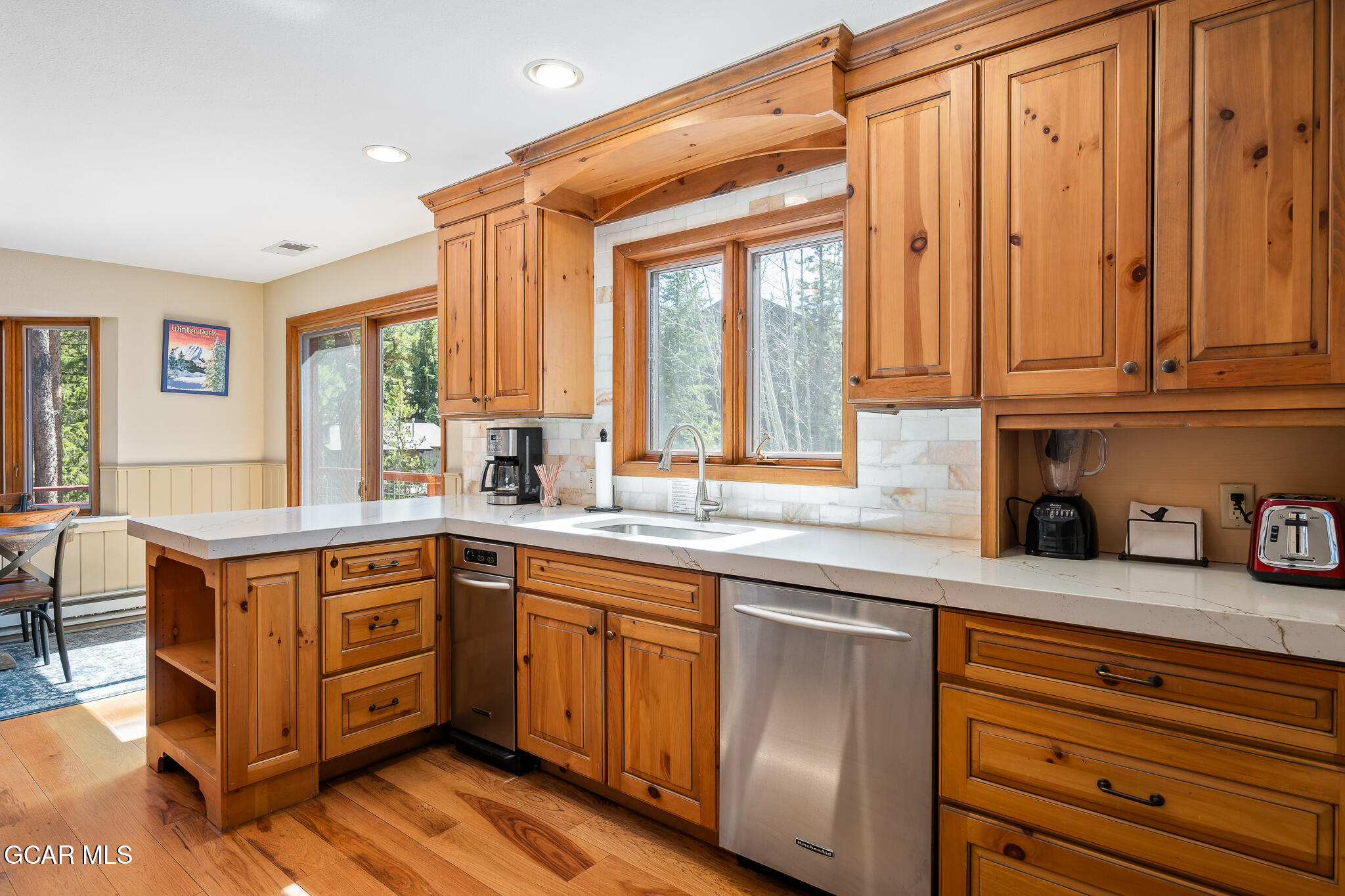 614 Vasquez Road Winter Park, CO 80482 - Photo 17 of 52 a kitchen with stainless steel appliances granite countertop a sink and cabinets with wooden floor