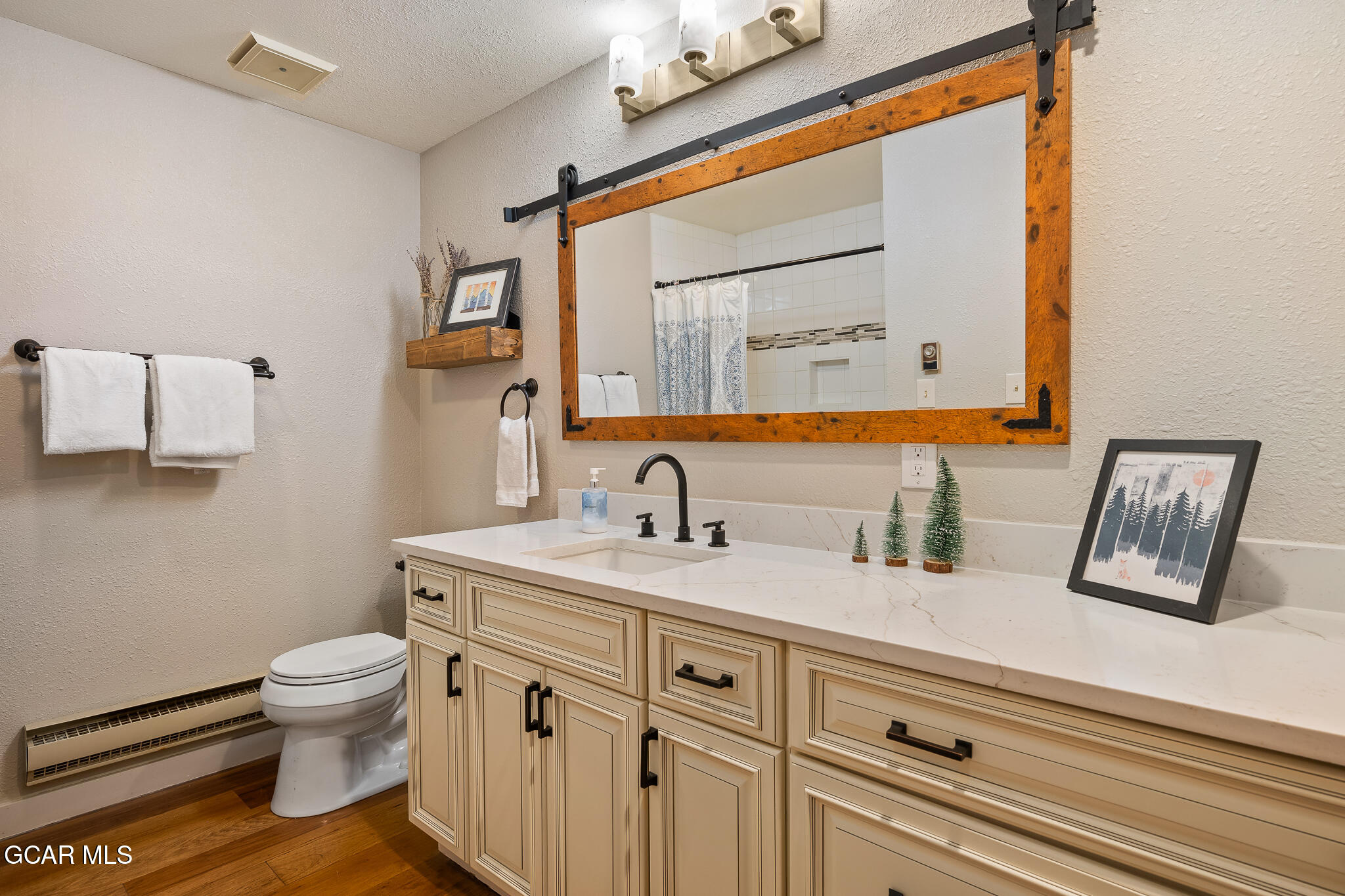 614 Vasquez Road Winter Park, CO 80482 - Photo 19 of 52 a bathroom with a granite countertop sink mirror vanity and toilet