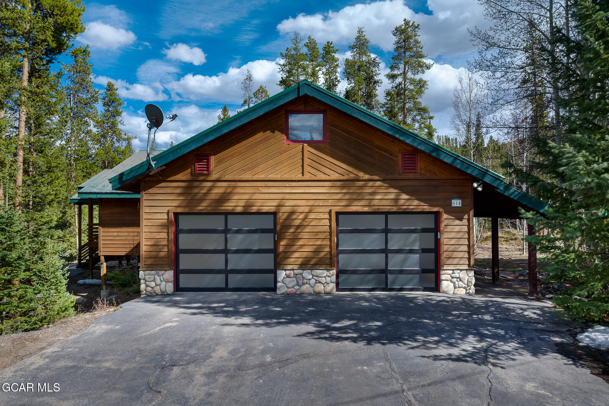 614 Vasquez Road Winter Park, CO 80482 - Photo 2 of 52 a front view of a house with a yard and garage