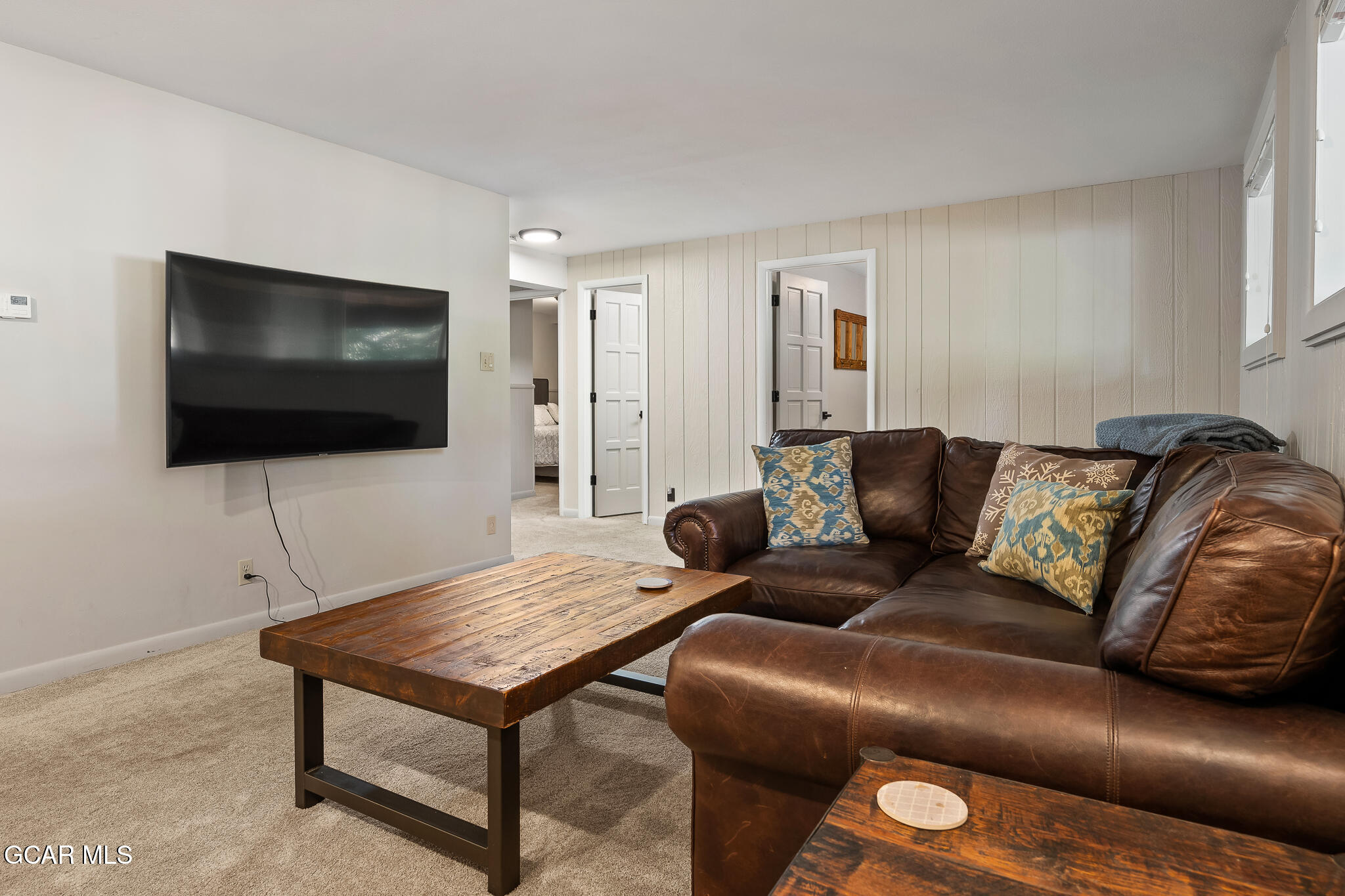 614 Vasquez Road Winter Park, CO 80482 - Photo 28 of 52 a living room with furniture and a flat screen tv