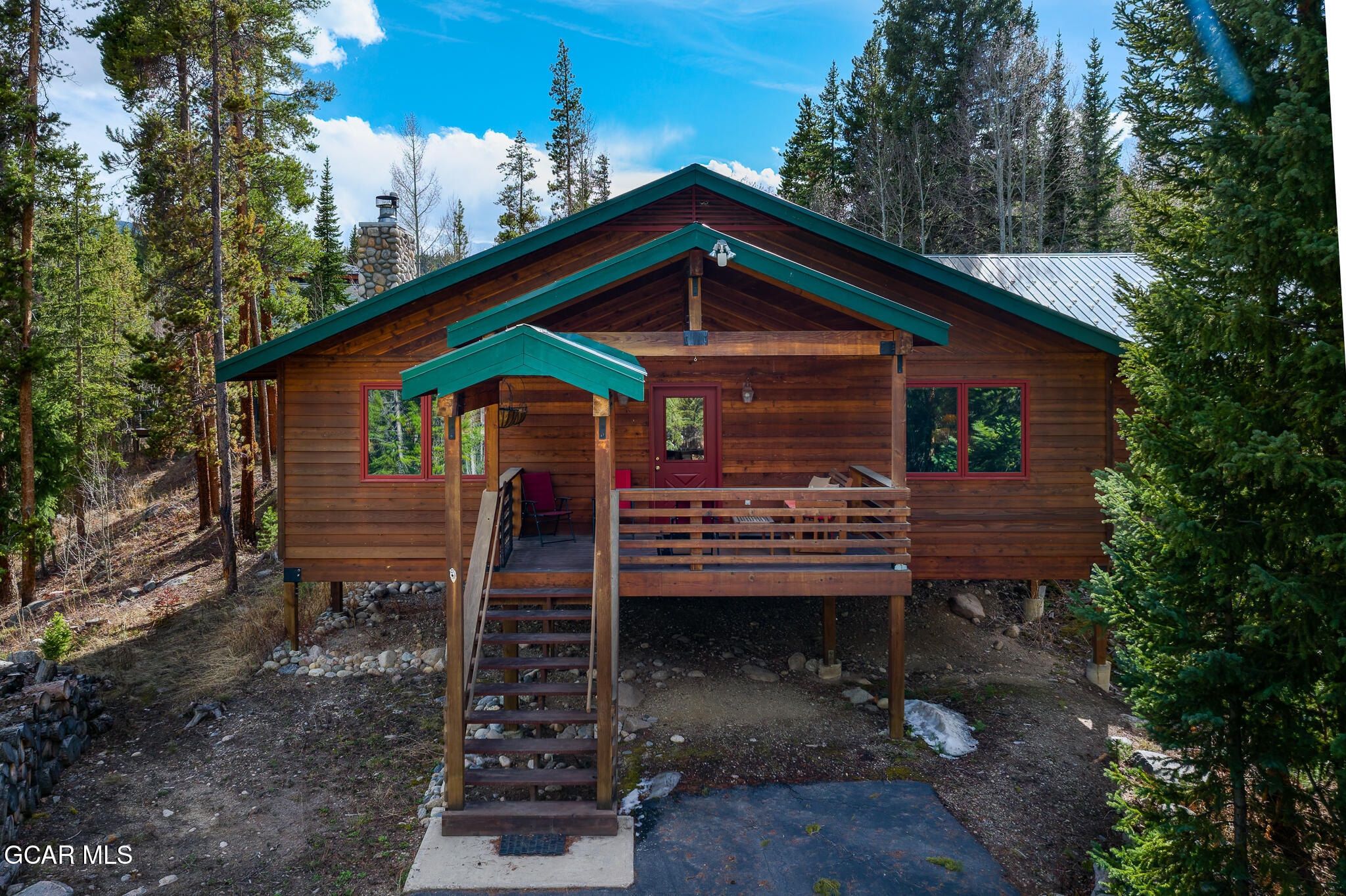 614 Vasquez Road Winter Park, CO 80482 - Photo 3 of 52 a backyard of a house with barbeque oven and outdoor seating