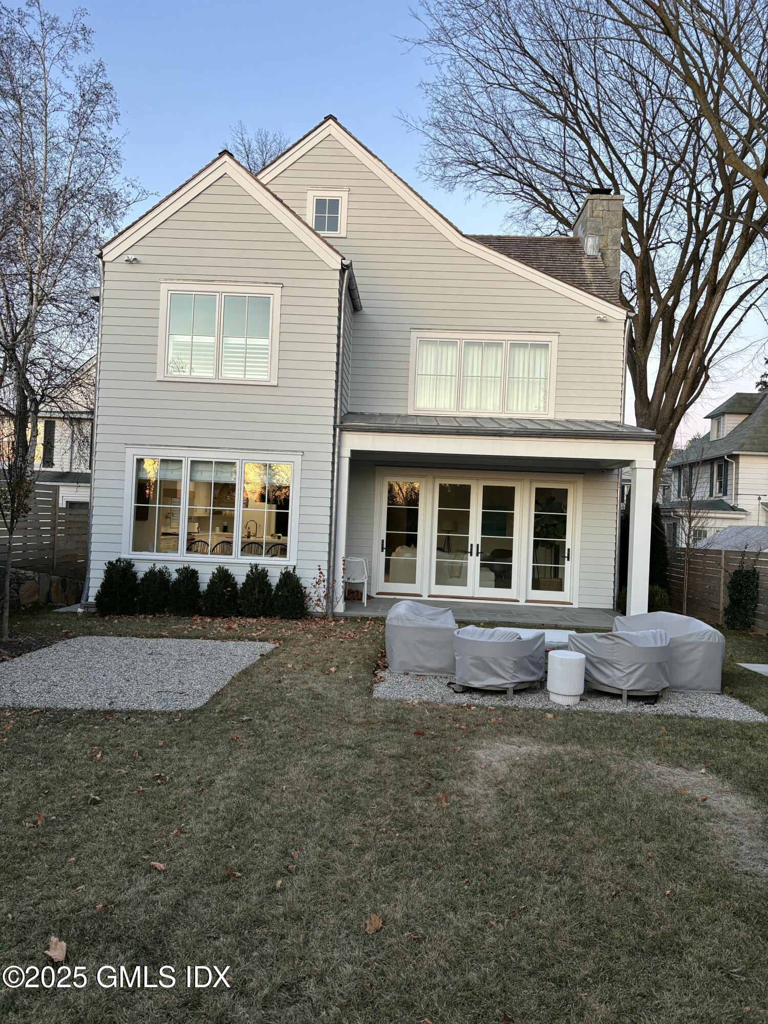 119 Havemeyer Place Greenwich, CT 06830 - Photo 3 of 7 a front view of a house with a yard