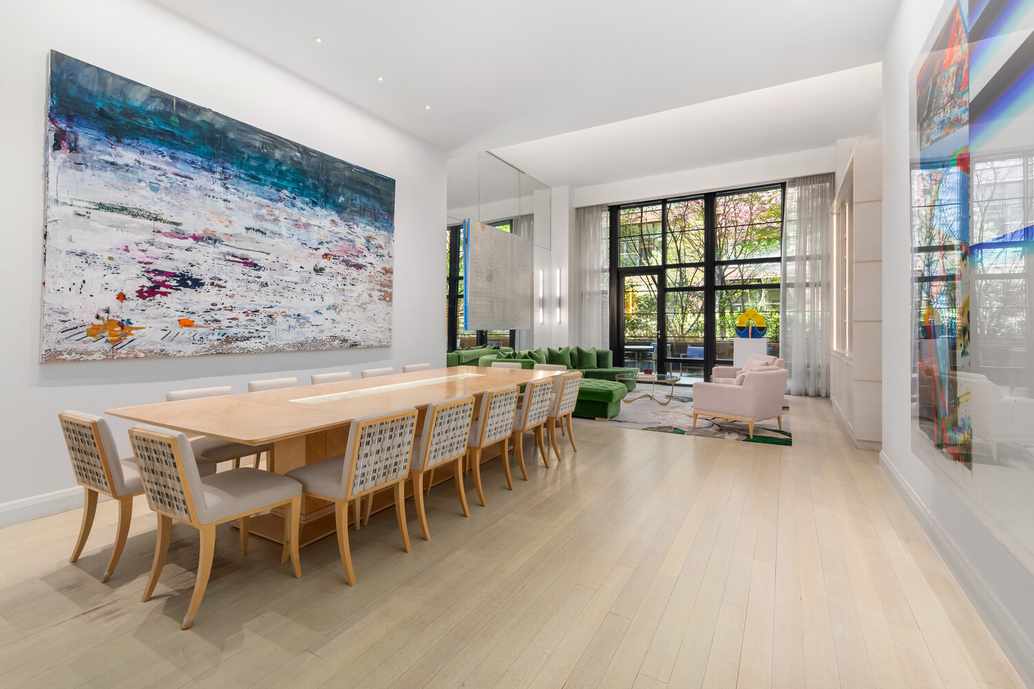 a living room with furniture a large window and a table
