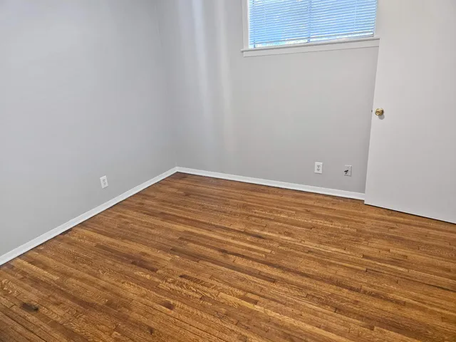 an empty room with wooden floor