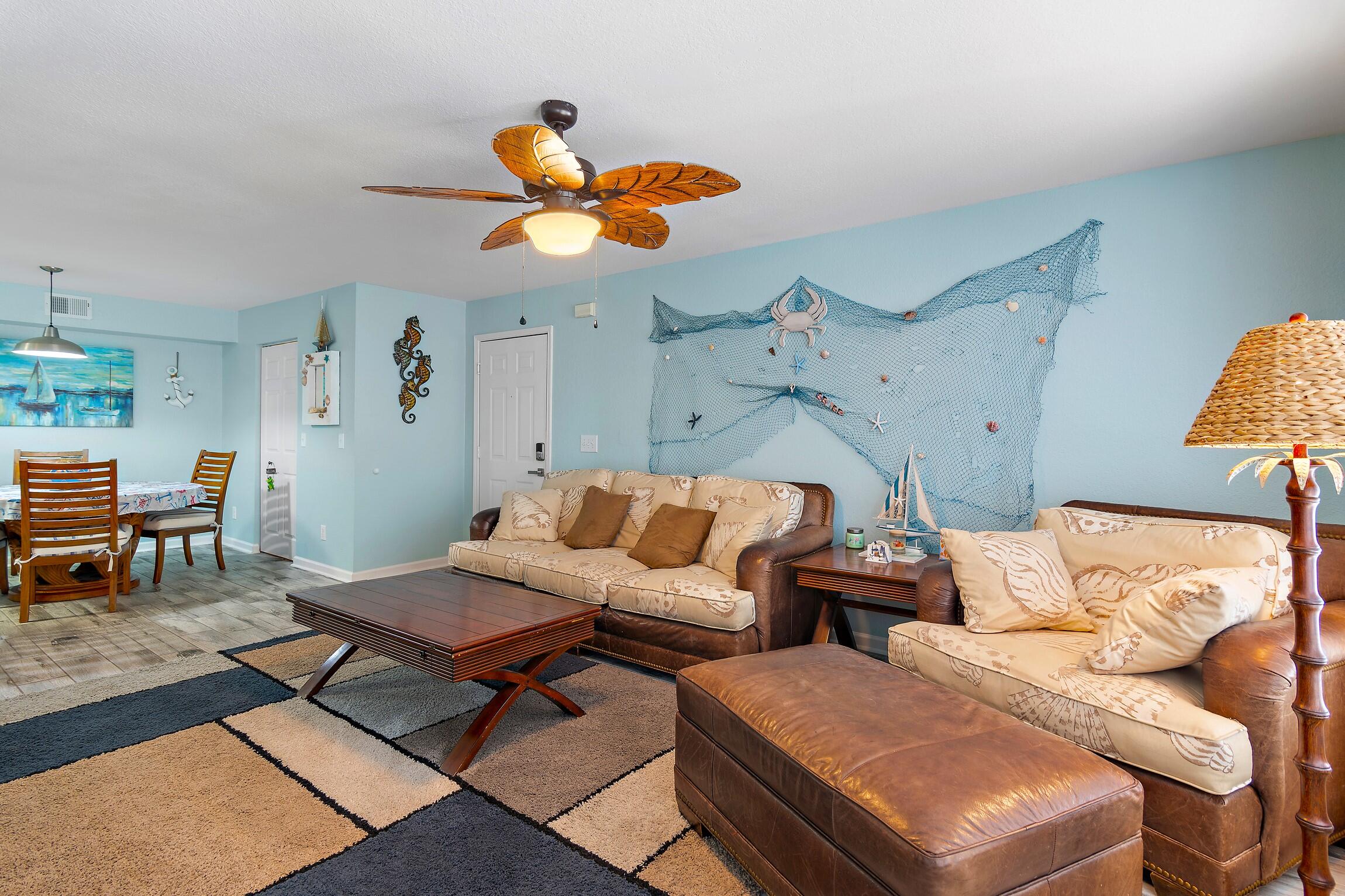 4010 Dancing Cloud Court, Unit 404 Destin, FL 32541 - Photo 13 of 44 a living room with furniture and a dining area with rug