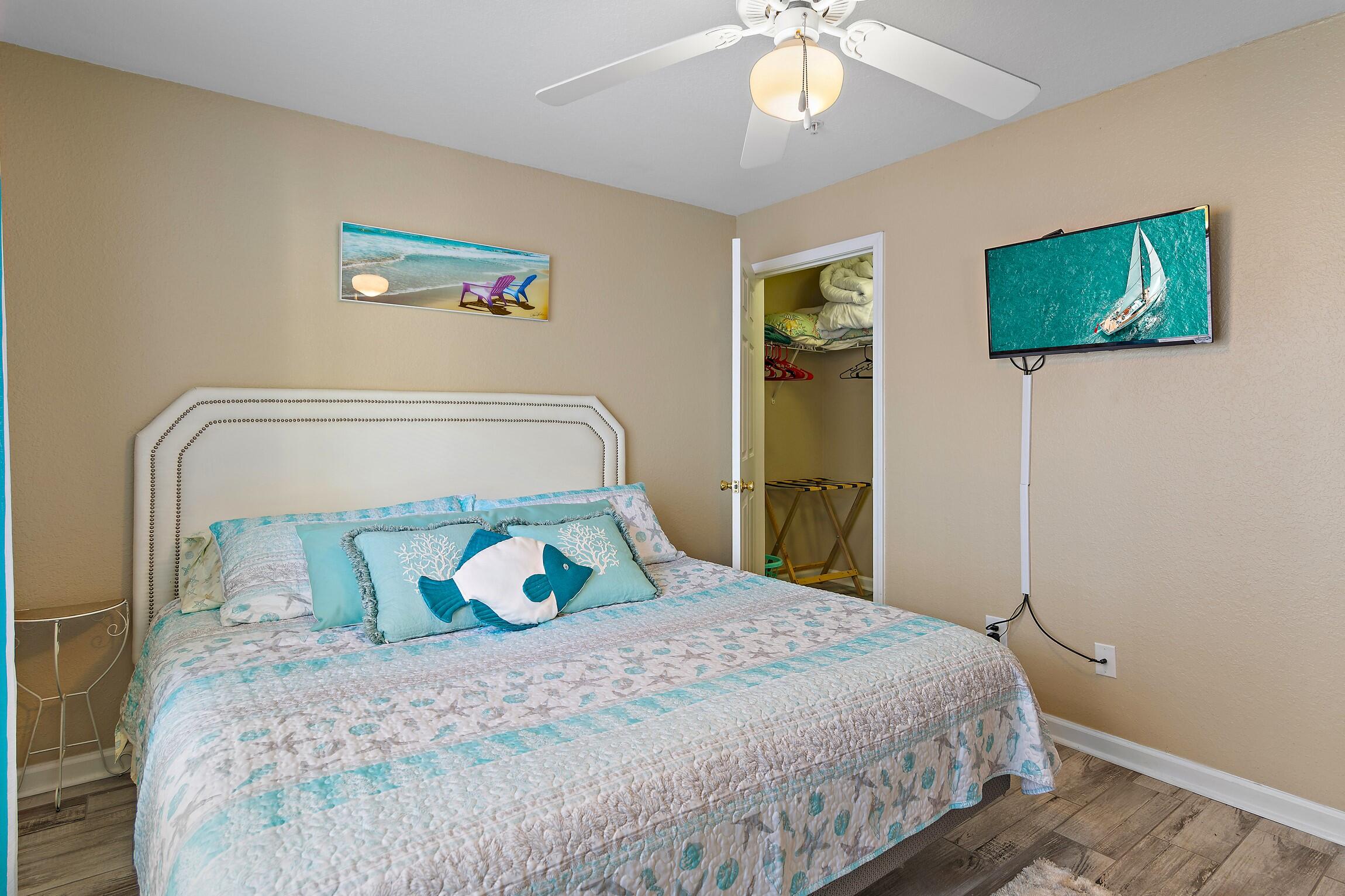 4010 Dancing Cloud Court, Unit 404 Destin, FL 32541 - Photo 17 of 44 a bedroom with a bed and a chandelier