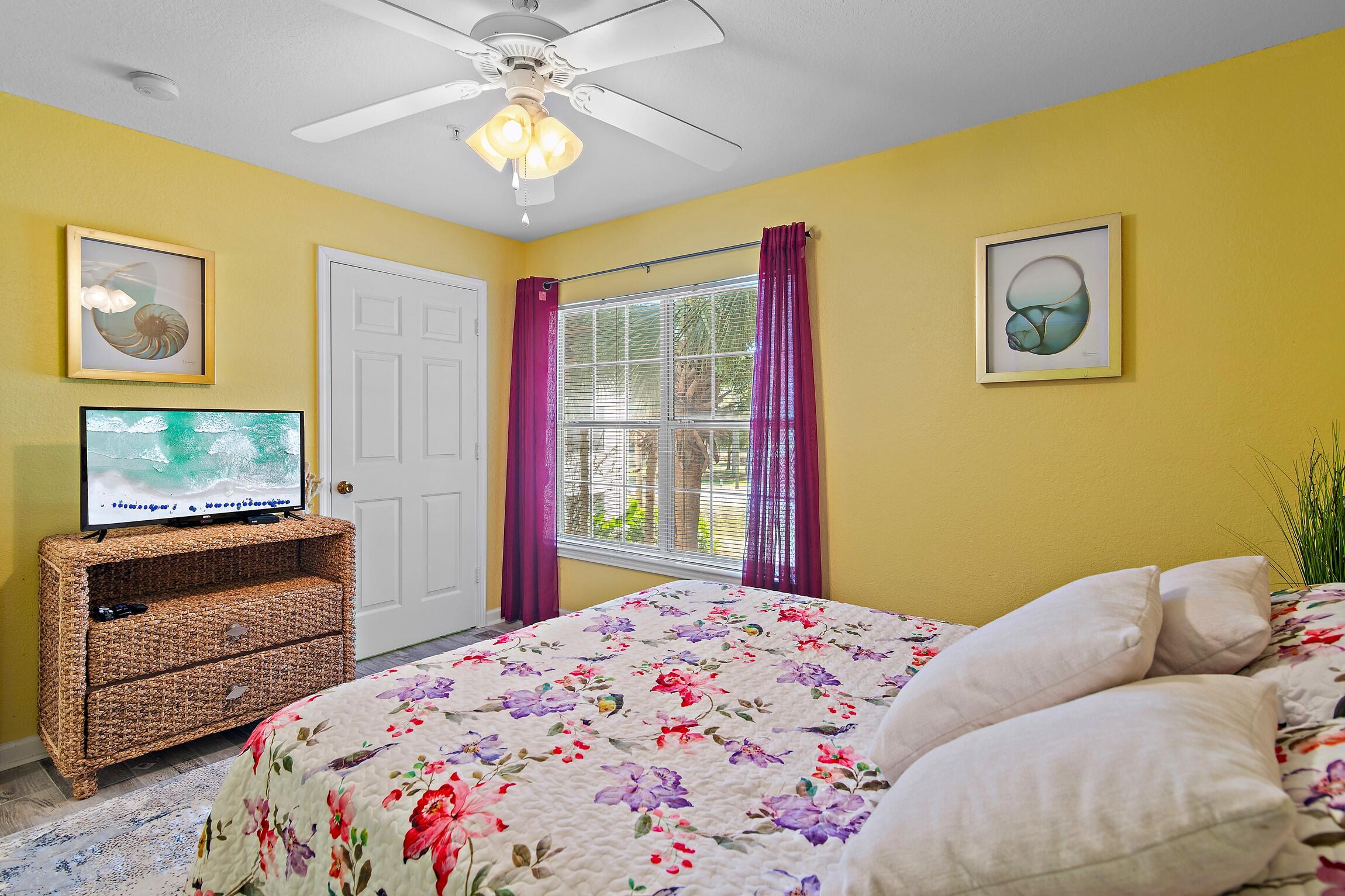 4010 Dancing Cloud Court, Unit 404 Destin, FL 32541 - Photo 19 of 44 a bedroom with a bed and a chandelier