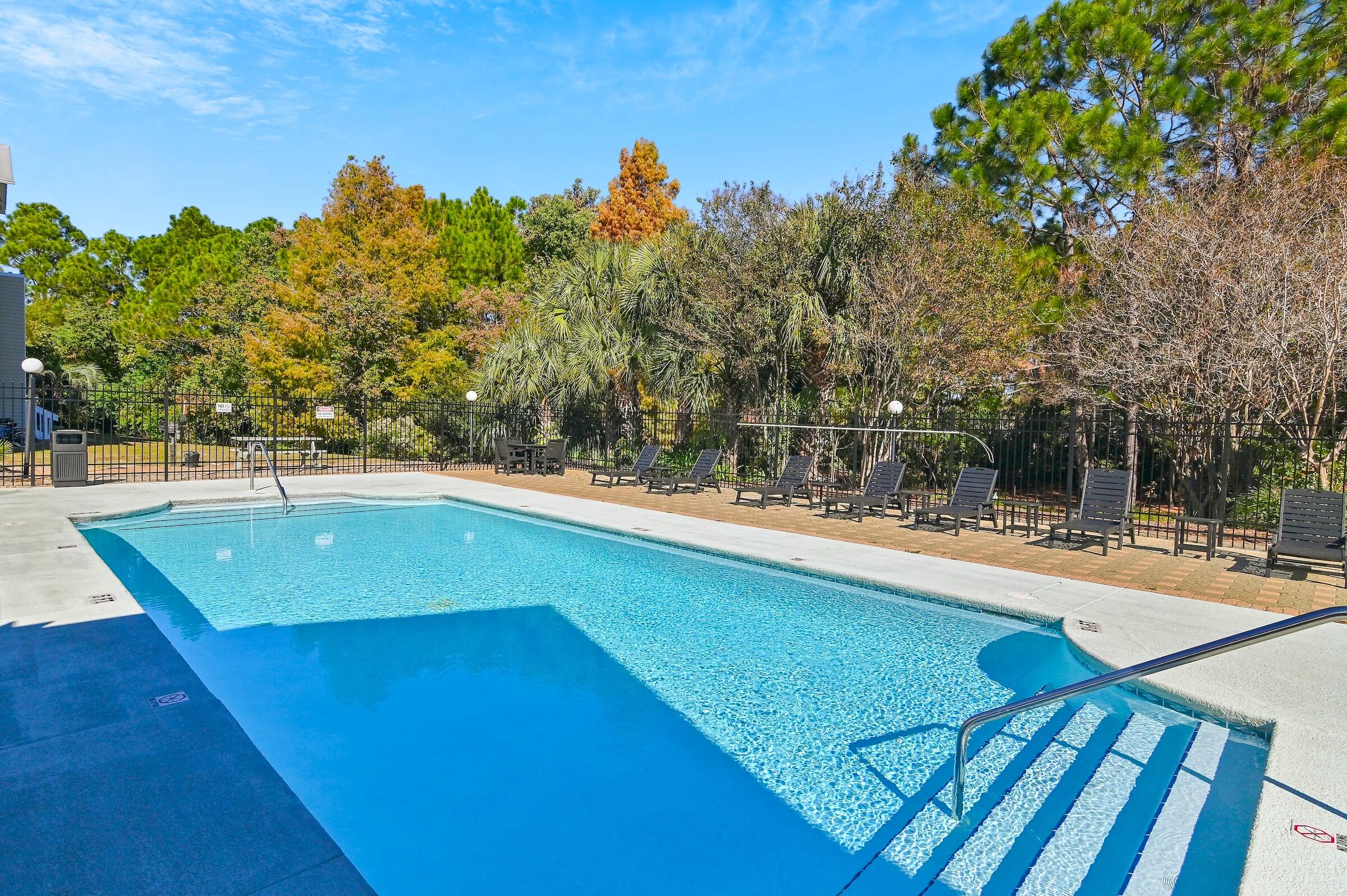 4010 Dancing Cloud Court, Unit 404 Destin, FL 32541 - Photo 28 of 44 a view of a swimming pool with an outdoor seating and a garden