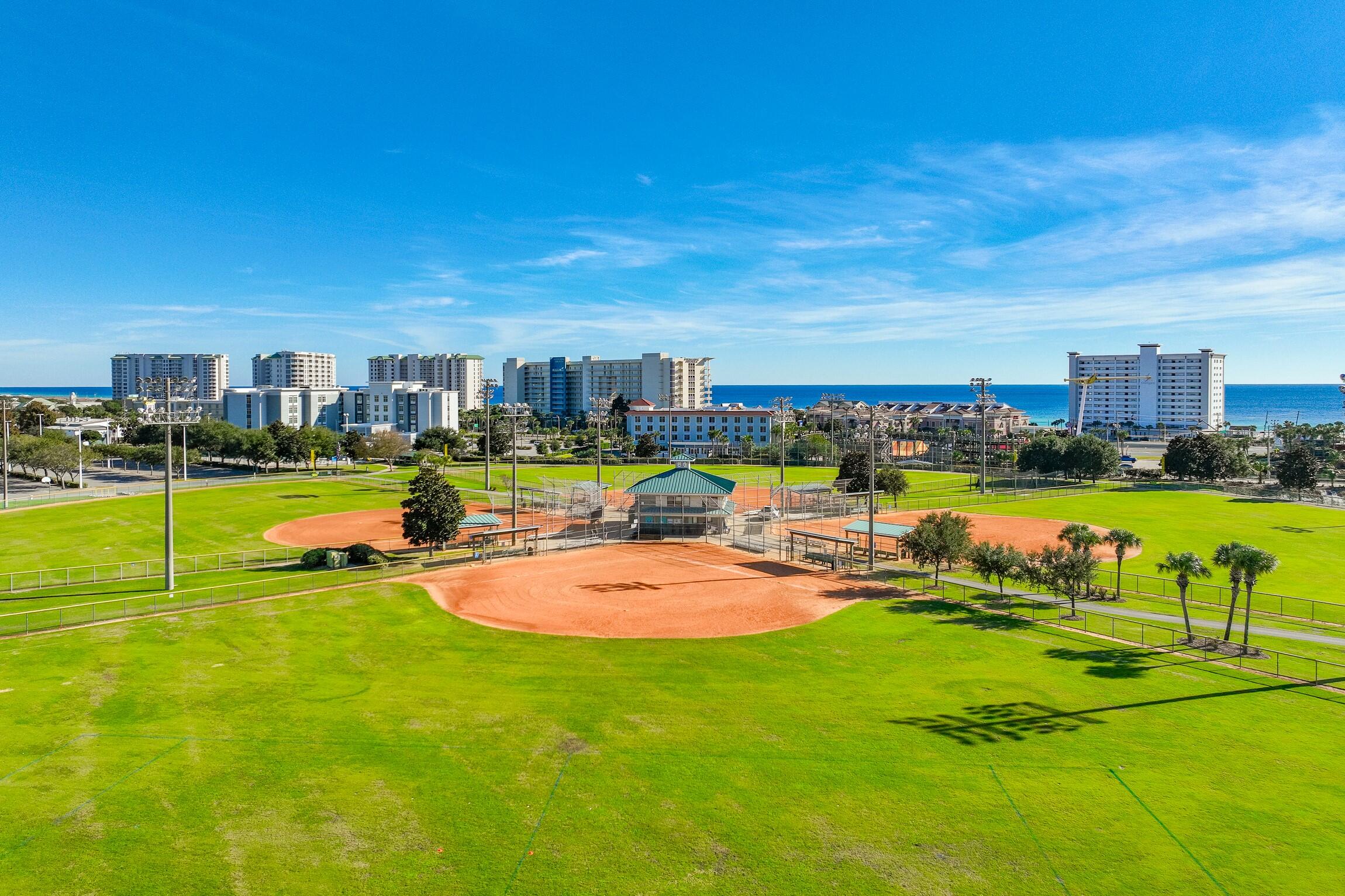 4010 Dancing Cloud Court, Unit 404 Destin, FL 32541 - Photo 35 of 44 a view of a swimming pool with lawn chairs and a big yard