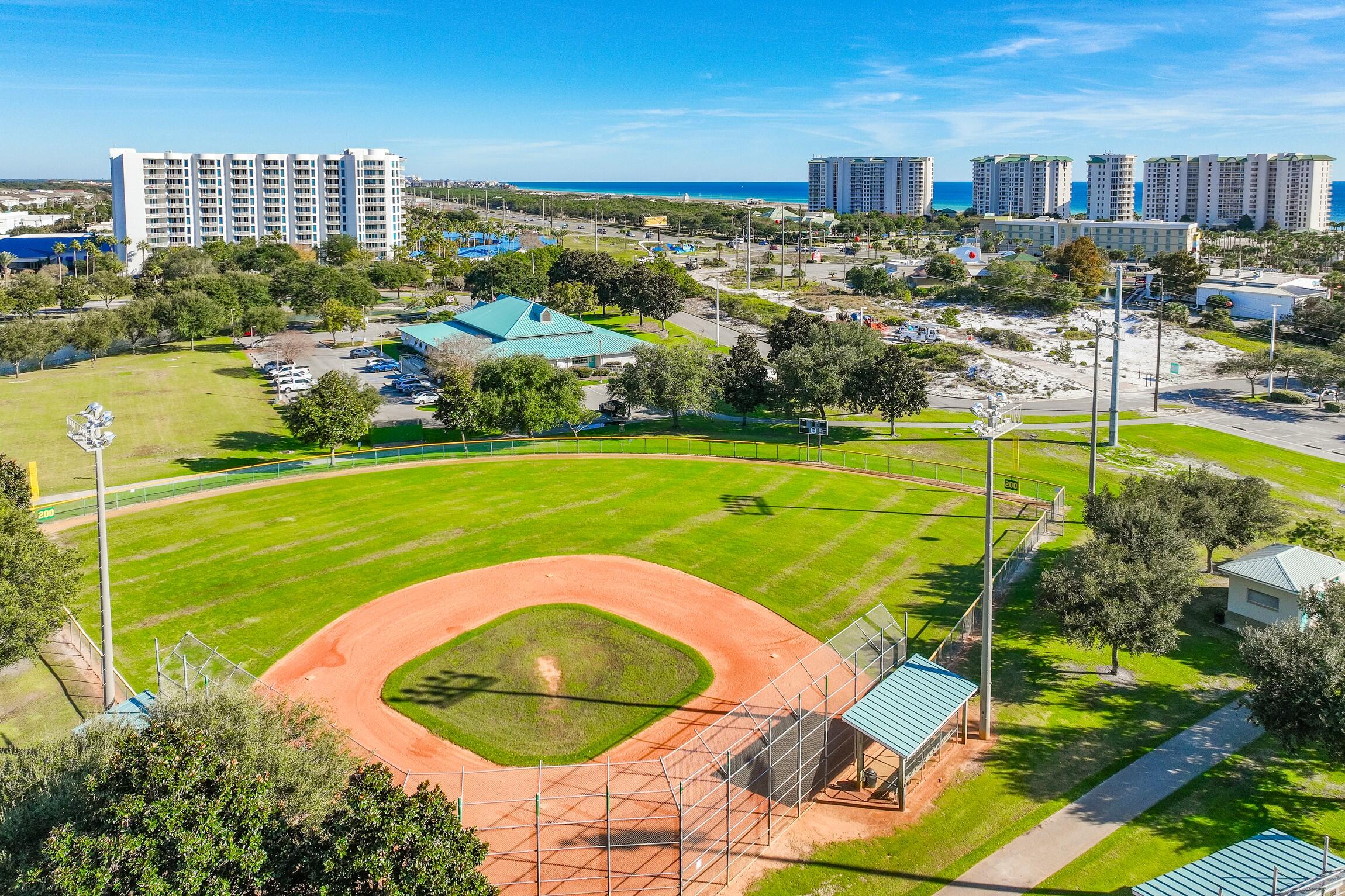4010 Dancing Cloud Court, Unit 404 Destin, FL 32541 - Photo 37 of 44 a view of a swimming pool with a patio and a yard